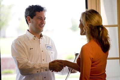 A tech shaking a woman's hand